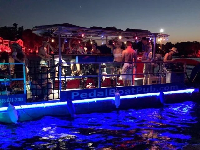 The Pedal Boat Pub lit up in blue at dusk